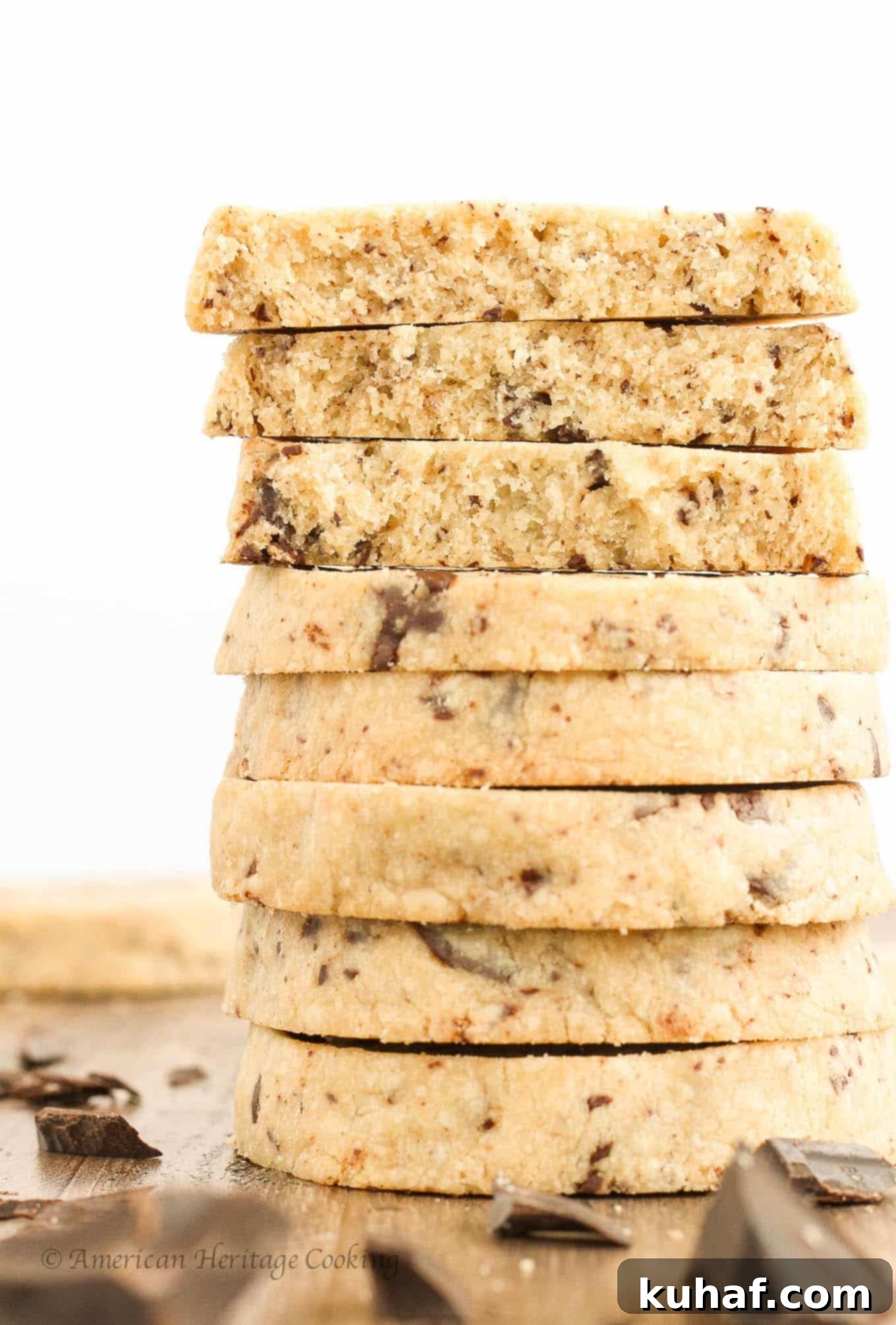 A beautiful stack of three golden brown chocolate chip shortbread cookies, showcasing their uniform shape and abundant chocolate.