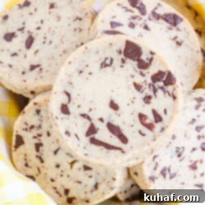 Chocolate Chip Shortbread Cookies arranged next to a yellow kitchen towel, ready for serving.