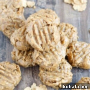 No Bake Peanut Butter Cookies stacked on wooden surface.
