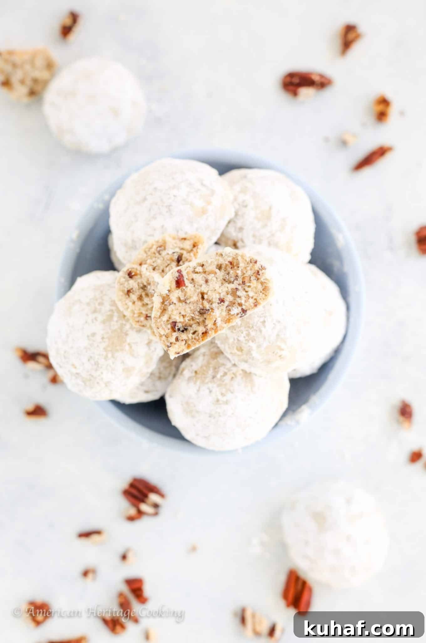 Fiesta Pecan Bites 3 Mexican wedding cookies on white countertop with pecans.