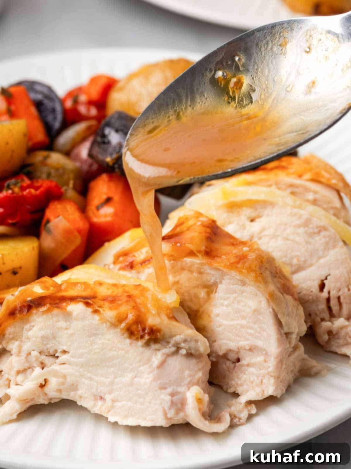adding pan sauce to sliced chicken.