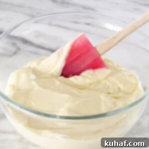 Vanilla Pastry Cream with a red silicone spatula, ready to be used as a filling for desserts.