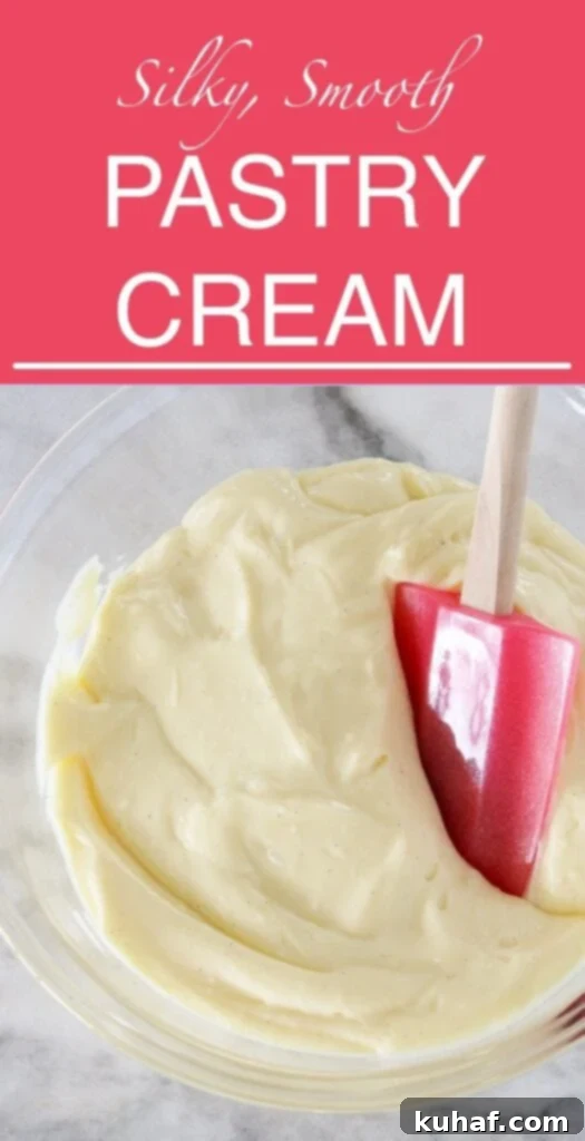 A large bowl of smooth vanilla pastry cream with a spatula, indicating a rich, luscious texture perfect for filling.