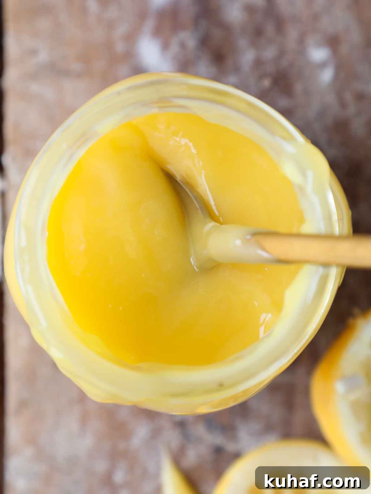 top of jar of lemon curd with spoon.