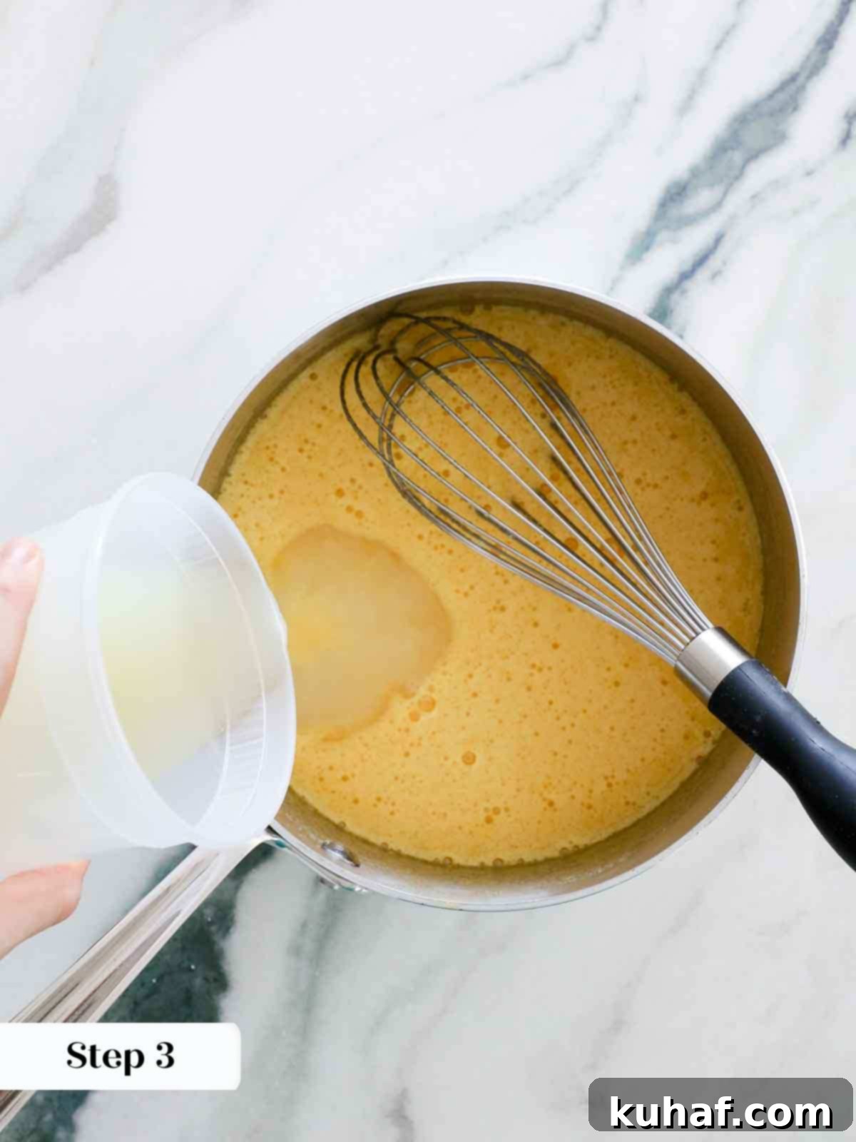 adding lemon juice to sugar and eggs for lemon curd.