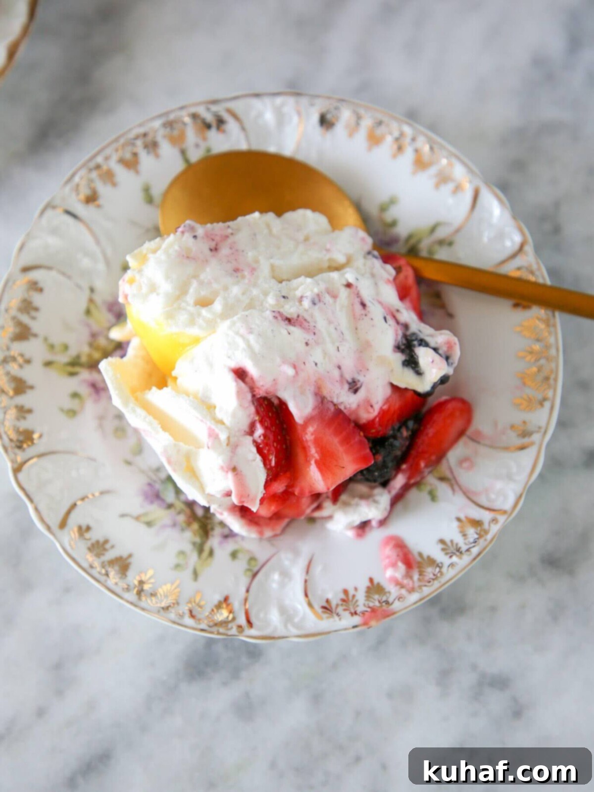 A serving of lemon berry pavlova cake on a white plate.