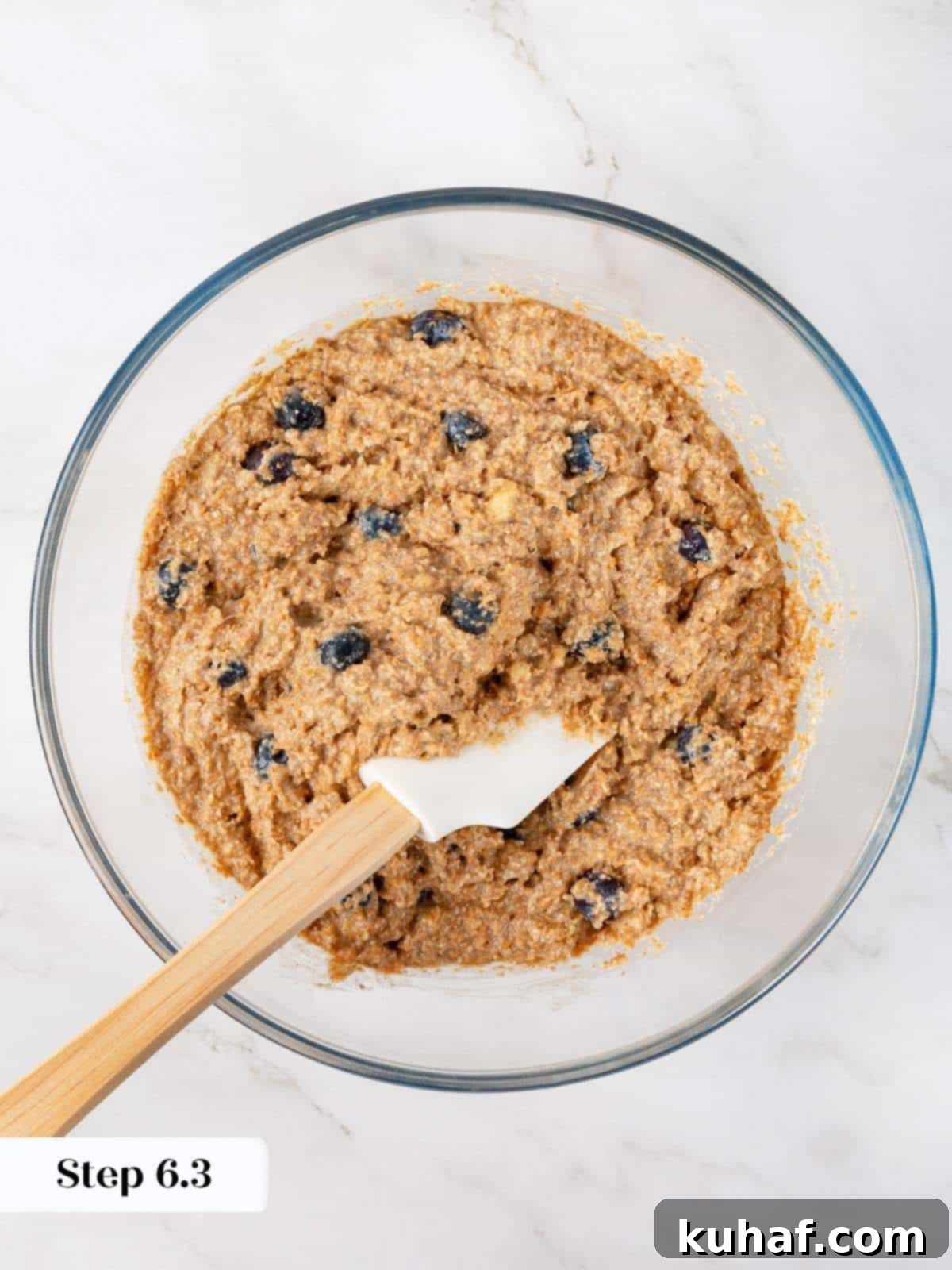 Thick, lumpy muffin batter with visible blueberries and bran, freshly mixed and ready to bake.