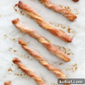 Sugary Cinnamon Spirals 5 Cinnamon Sugar Twists Baked on Parchment, showing golden brown texture.