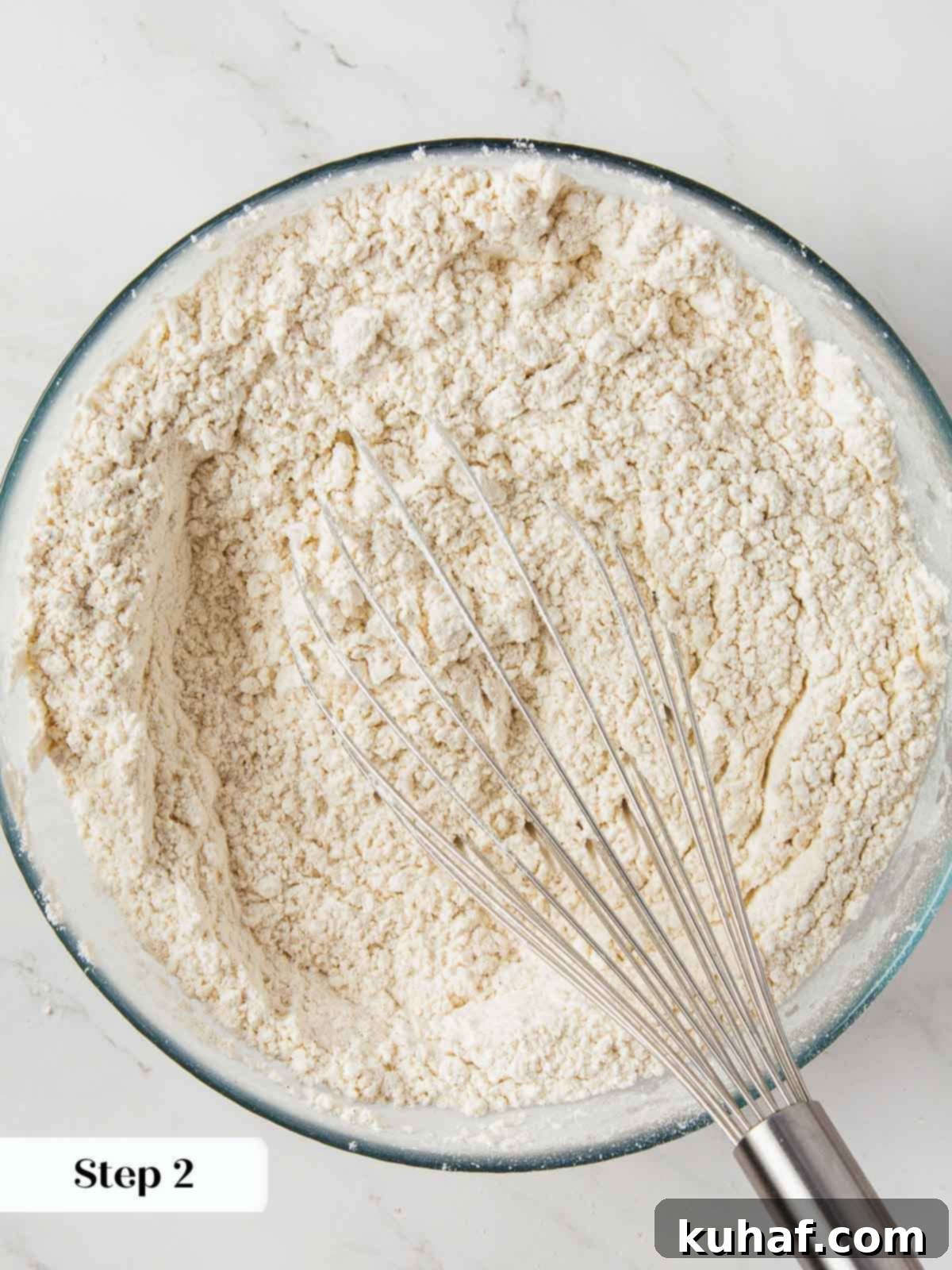 Dry ingredients for pumpkin bread being whisked together in a bowl.