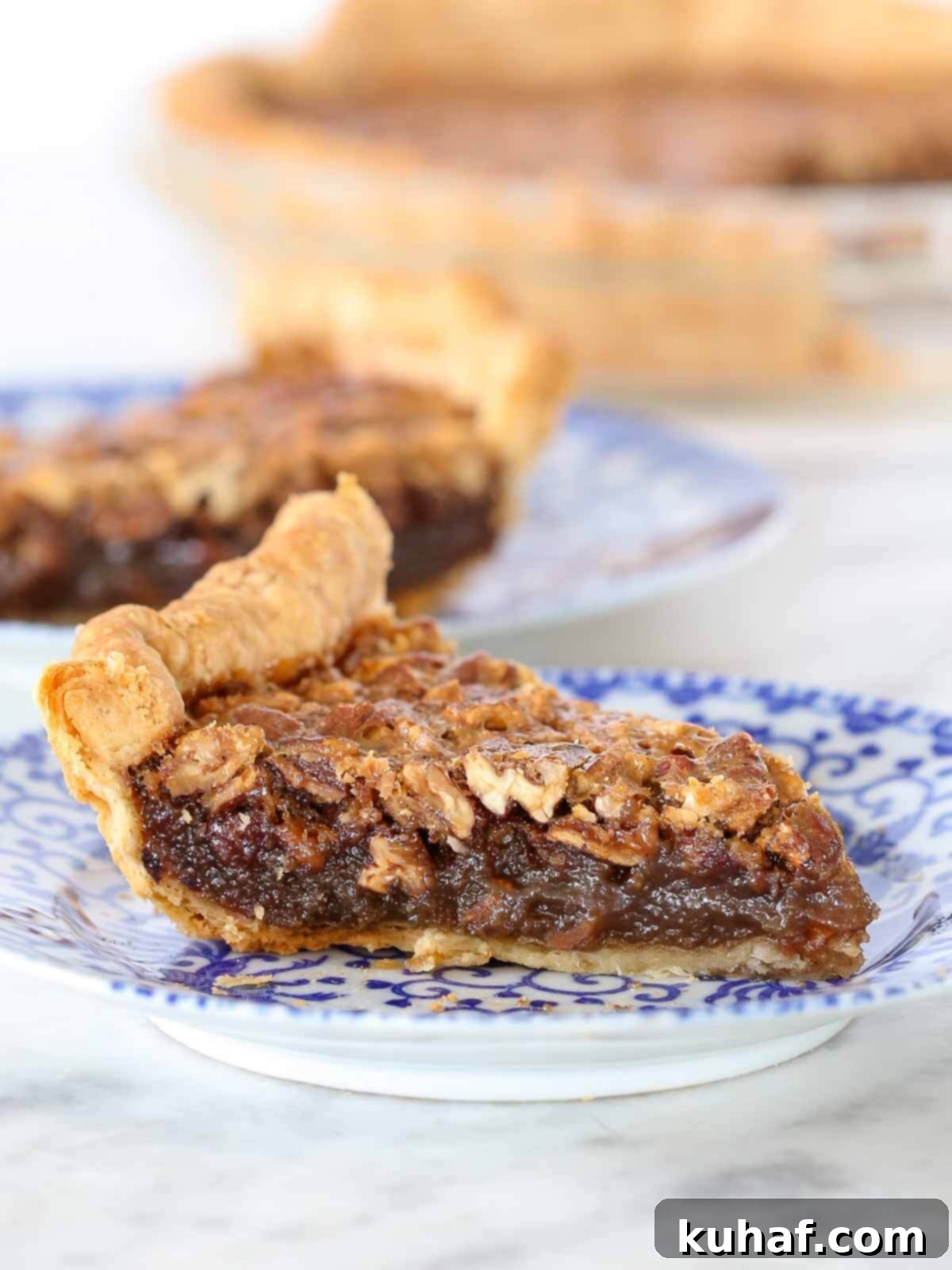 bourbon pecan pie slices on blue plates. 