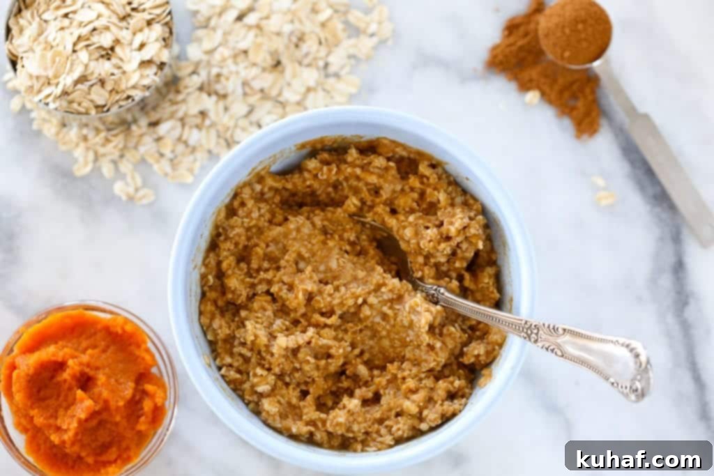 Spiced Pumpkin Harvest Oats 2 A steaming bowl of pumpkin spice oatmeal, garnished with pecans and a cinnamon stick, offering a warm hug on a chilly day.