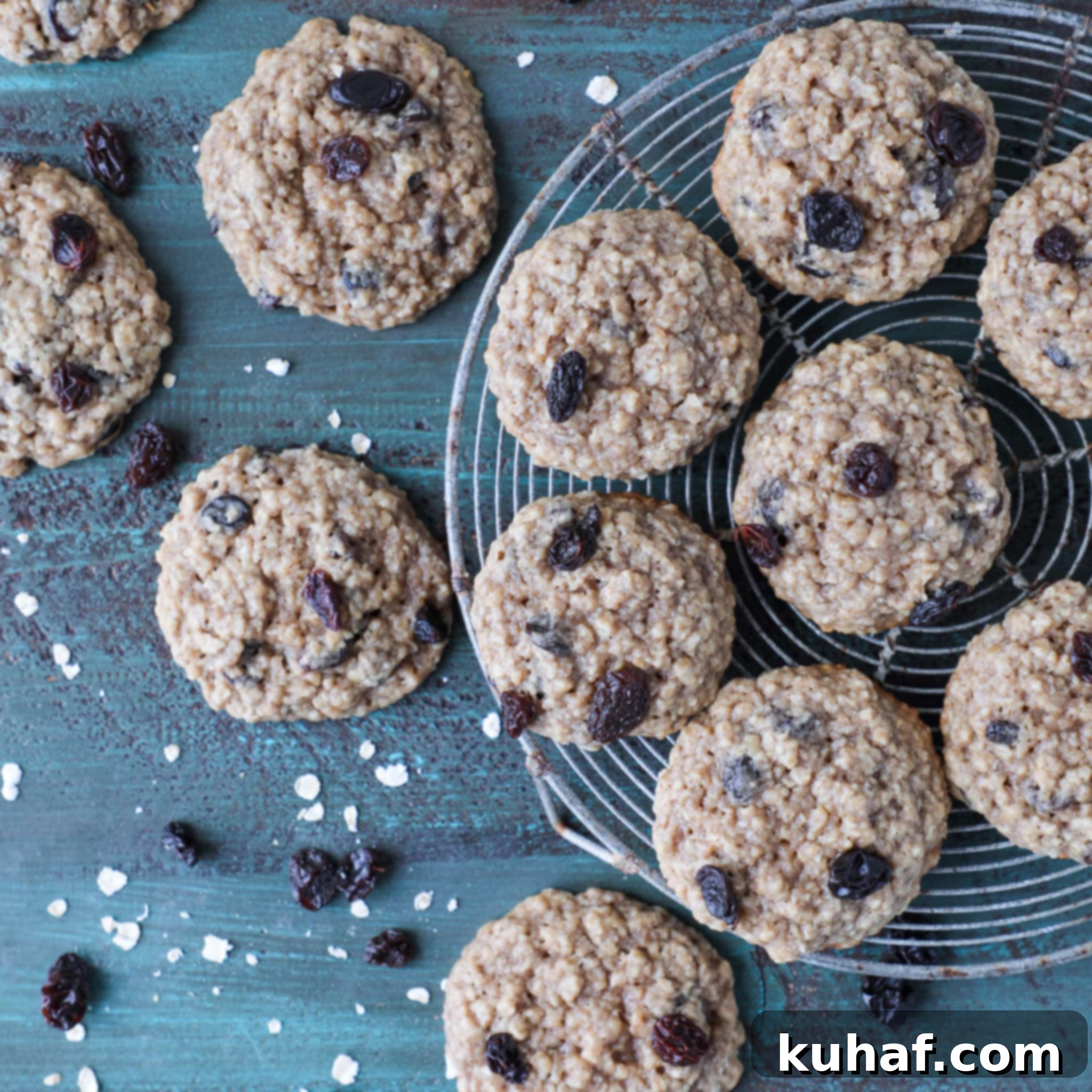 Old Fashioned Oatmeal Raisin cookies neatly arranged on a vibrant turquoise board, showcasing their golden-brown edges and plump raisins.
