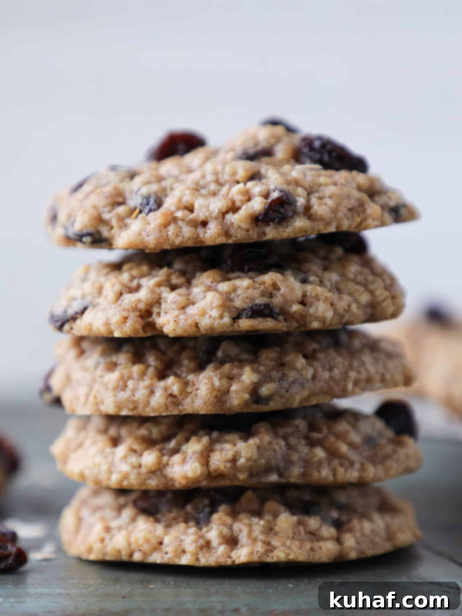Old Fashioned Oatmeal cookies stacked on top of each other, showcasing their soft, thick texture.