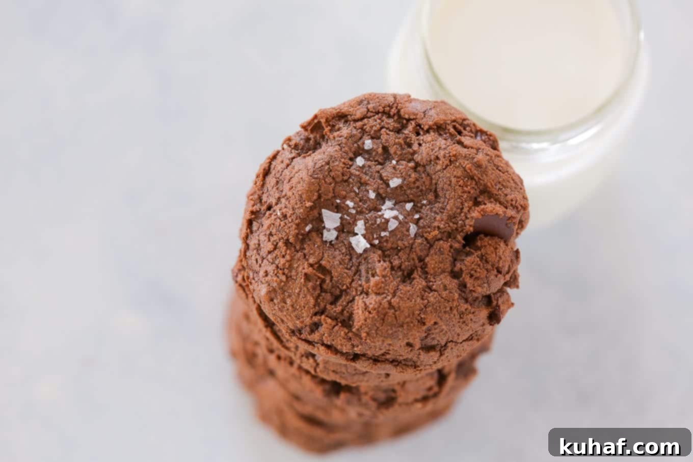 A stack of thick, fudgy double chocolate chip cookies.
