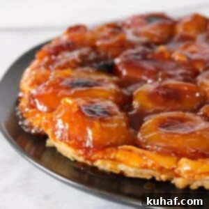 Apple Tarte Tatin on black plate.