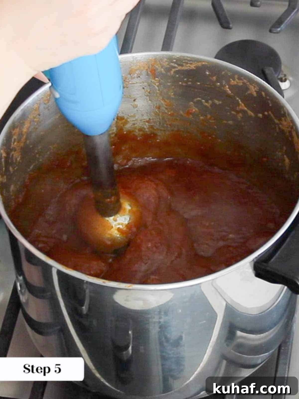 Caramelized Apple Spread 8 Immersion blending the cooked apples directly in the pot for a smooth texture.