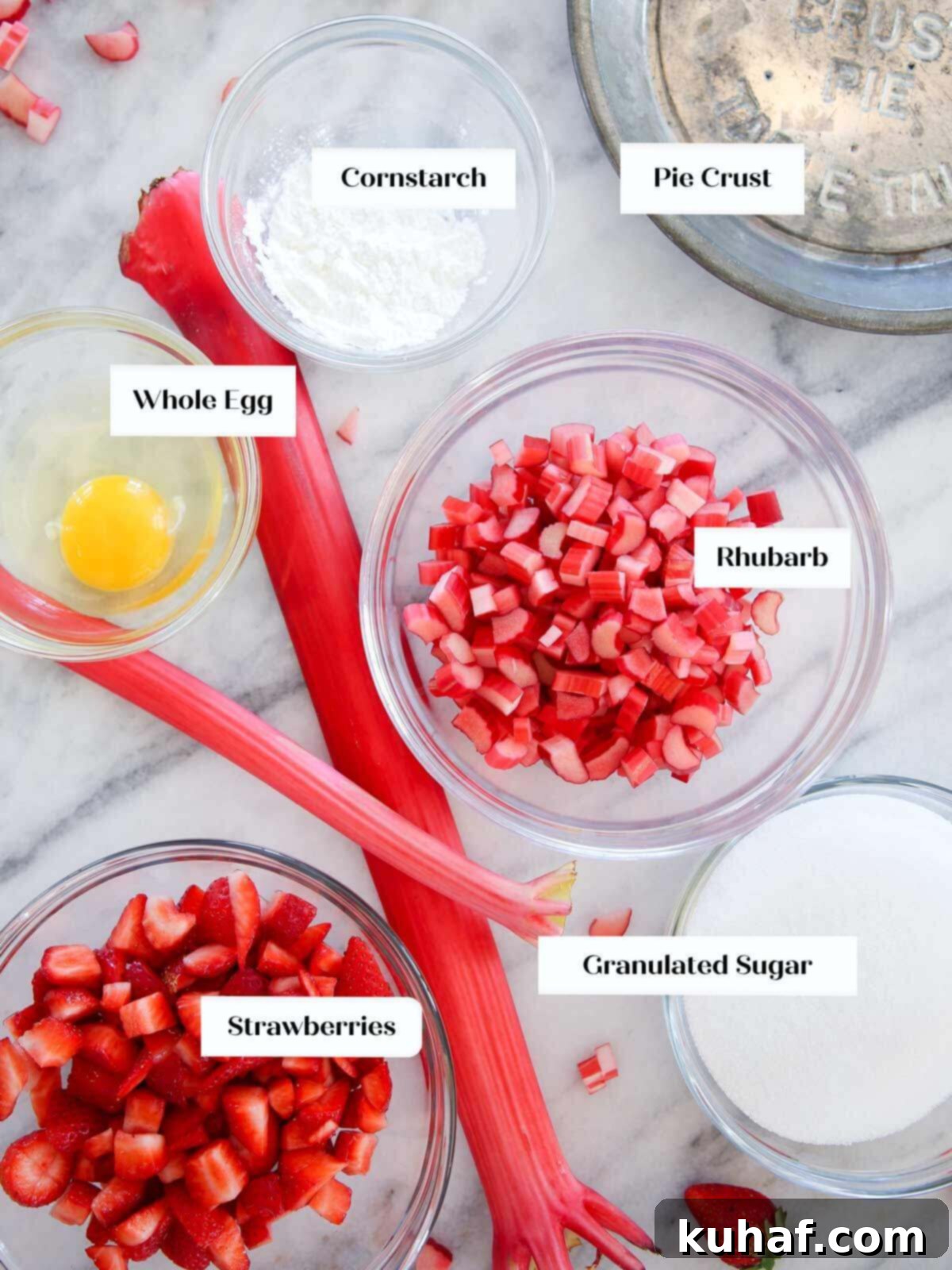 strawberry rhubarb pie ingredients on marble.