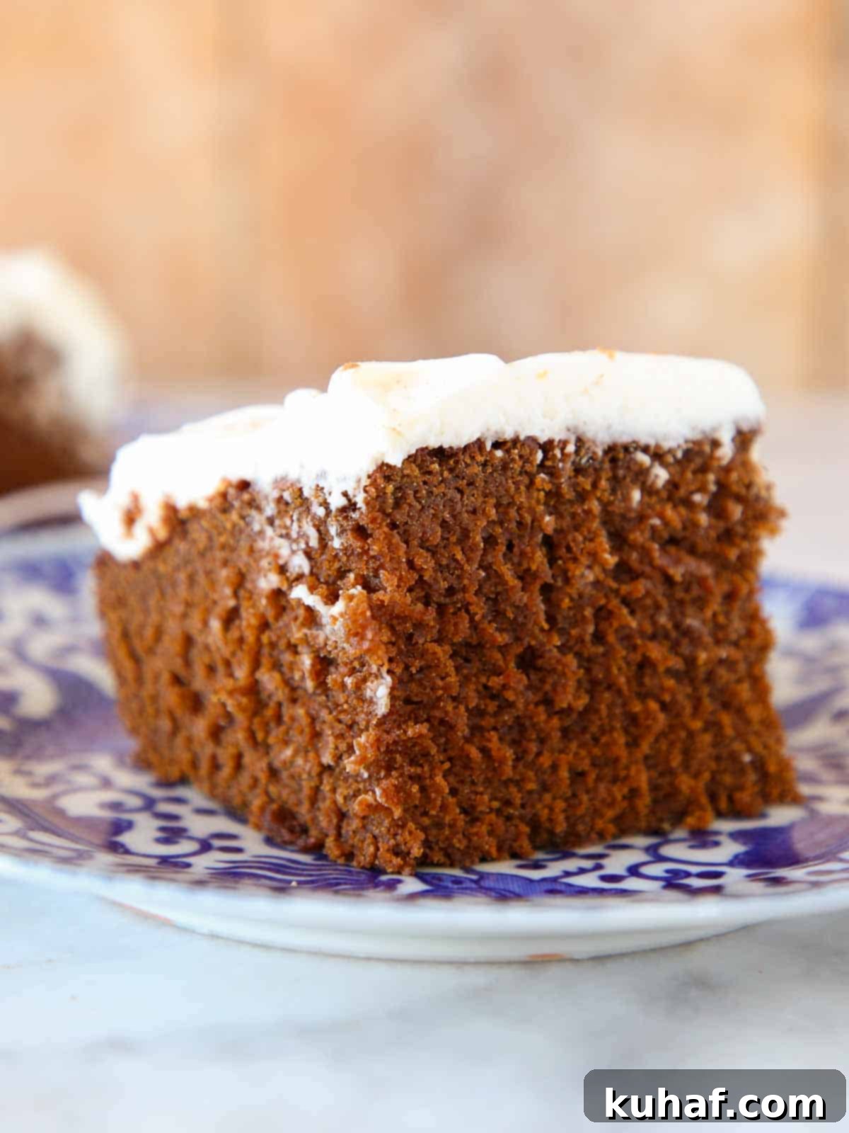 gingerbread cake slice with cream cheese frosting blue plate.