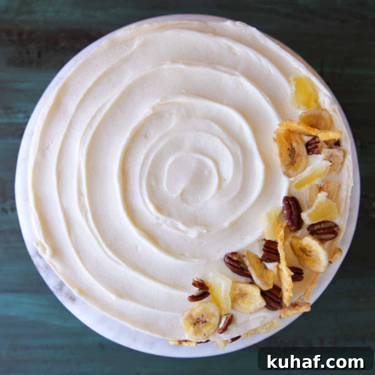 unsliced swirled cake with cream cheese buttercream.