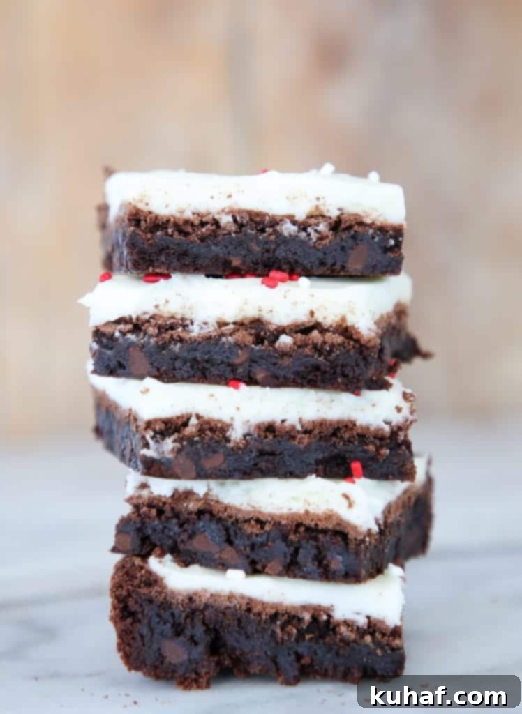 These Peppermint Triple Chocolate Brownies are rich, decadent and festive! Chewy brownies topped with an easy peppermint frosting!