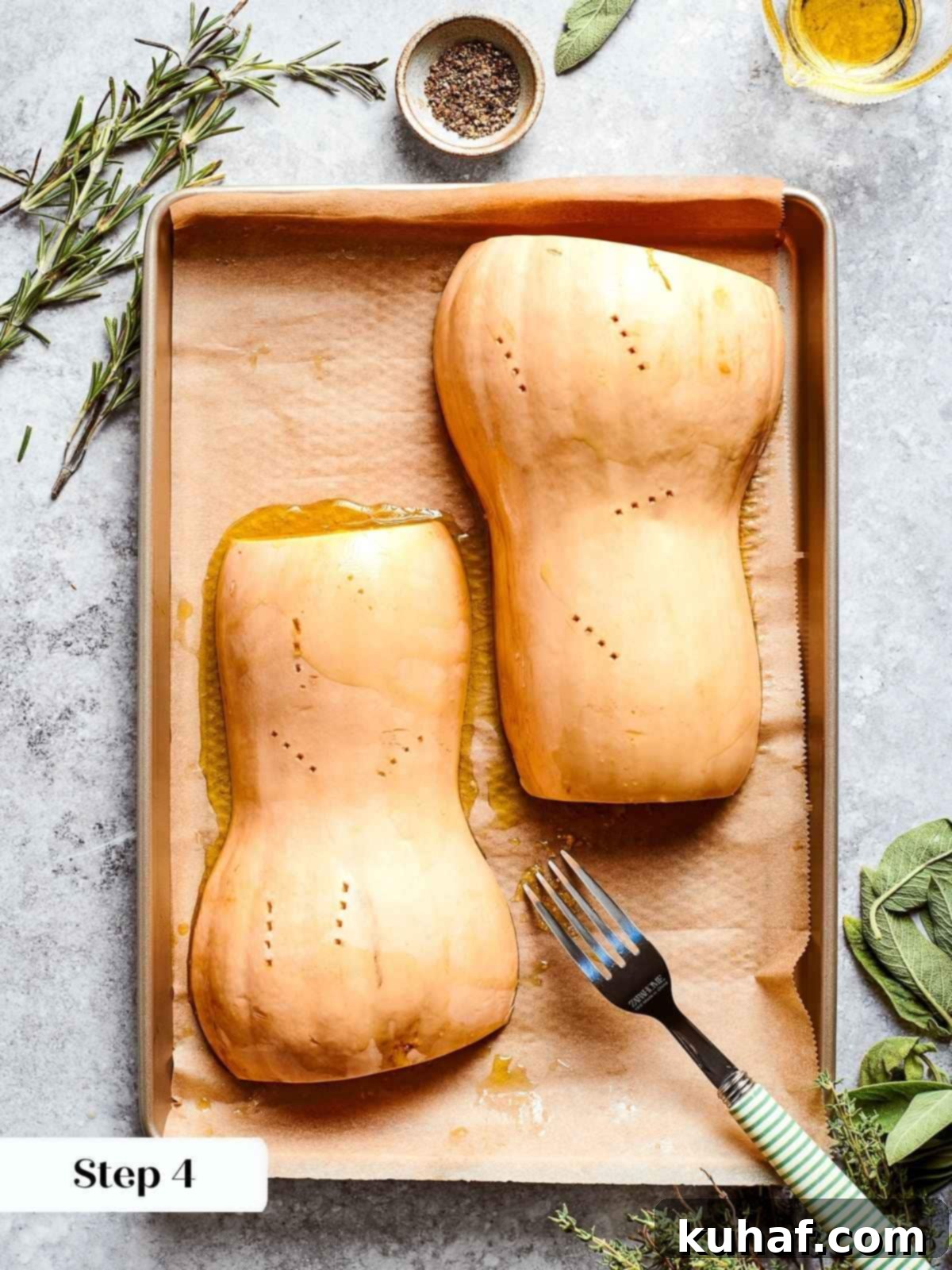 Squash halves placed face down on tray, ready to caramelize in oven.