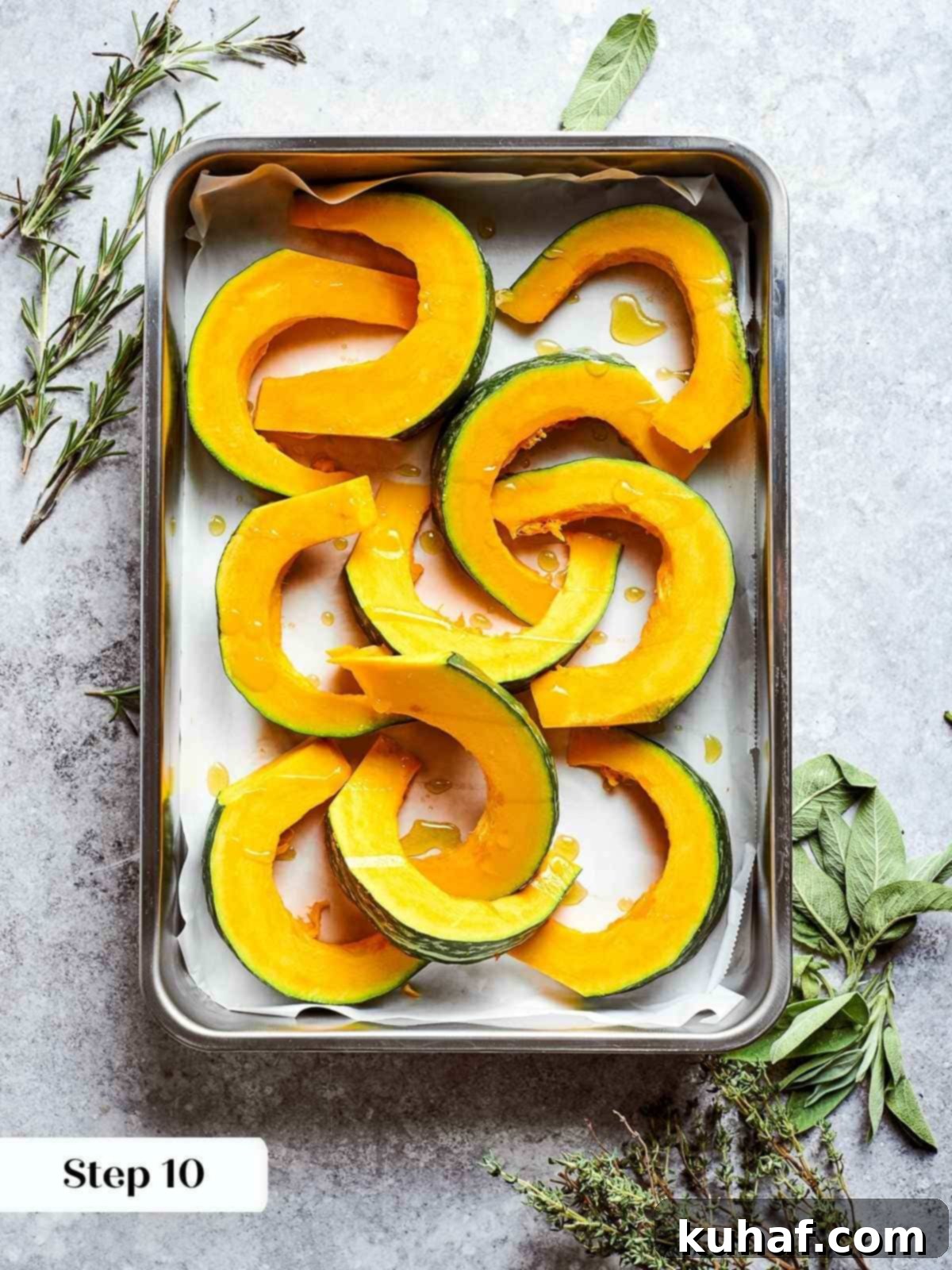 Fresh kabocha squash chunks arranged on baking sheet before roasting.