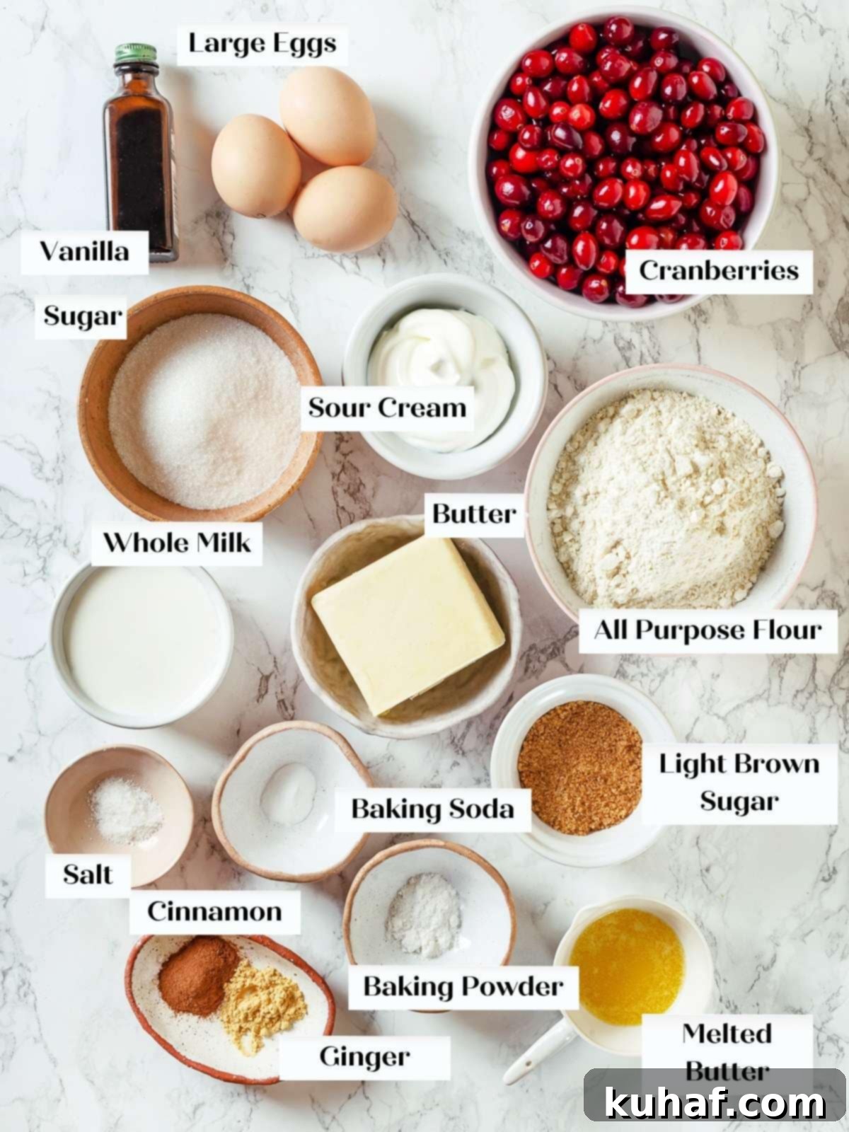 Measured cranberry cake ingredients arranged neatly on a white countertop ready for baking.