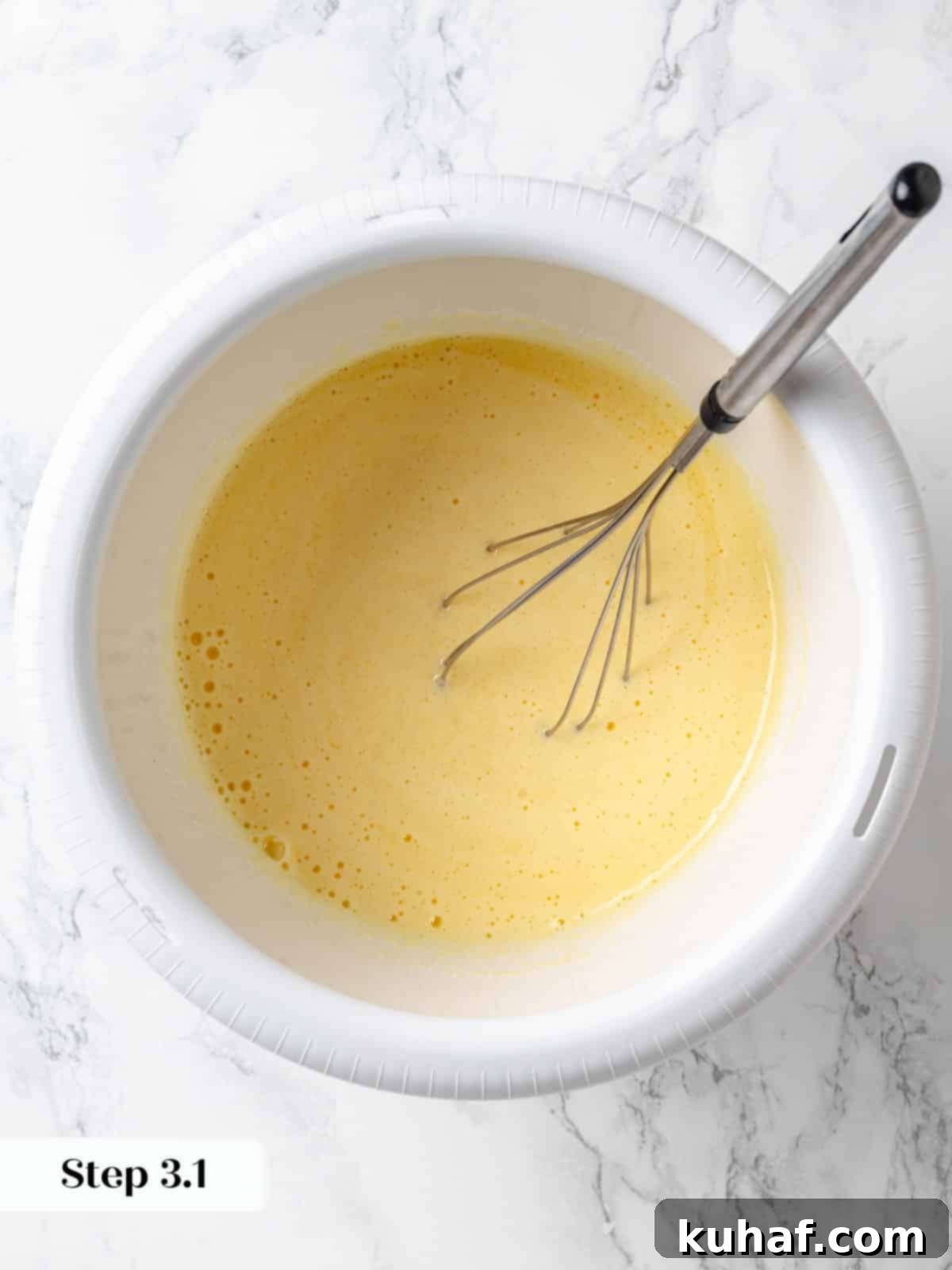 Eggs, vanilla extract, and sugar whisked together for the cake batter.