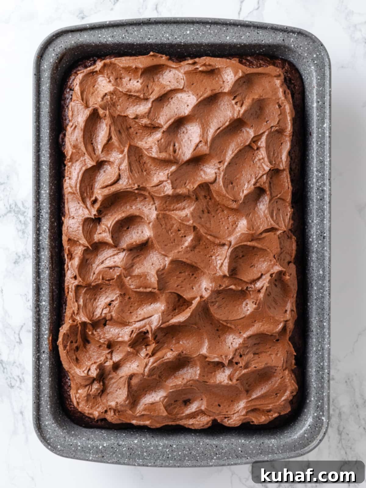 Chocolate Cream Cheese Dream Frosting 2 Chocolate cream cheese frosting spread showing soft waves and smooth texture.