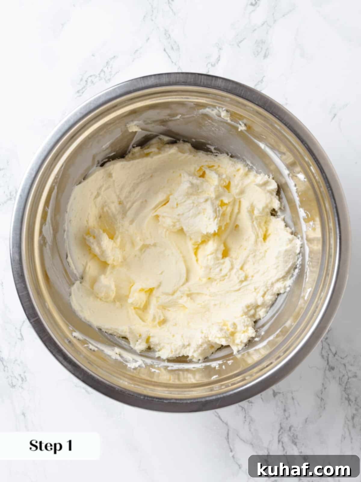 Chocolate Cream Cheese Dream Frosting 6 Cream cheese and butter being mixed together until smooth for chocolate frosting.