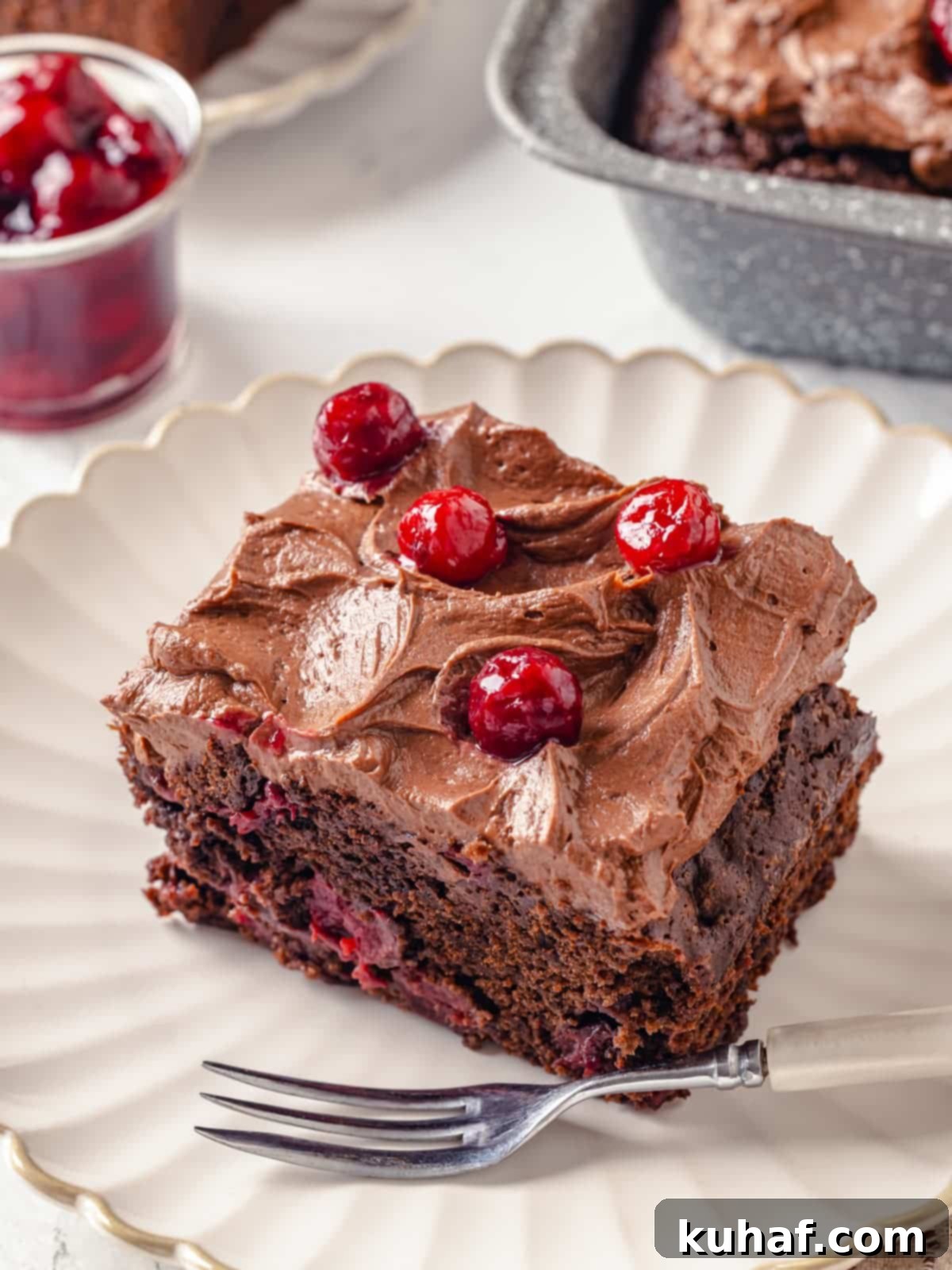 Chocolate Cream Cheese Dream Frosting 9 Rich chocolate cake topped with cream cheese frosting resting on a decorative plate.