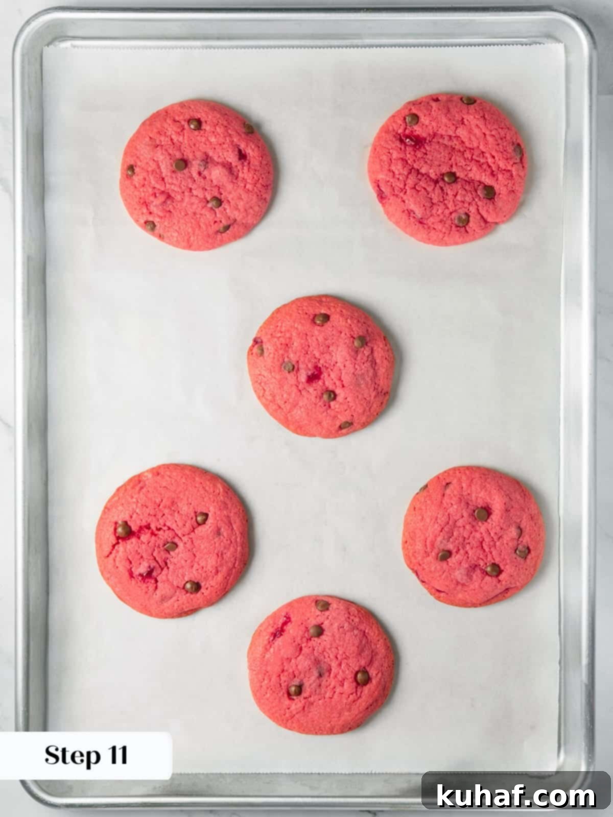 Cherry Chocolate Chunk Cookies 15 Cherry chocolate chip cookies finished baking with soft centers and red color.