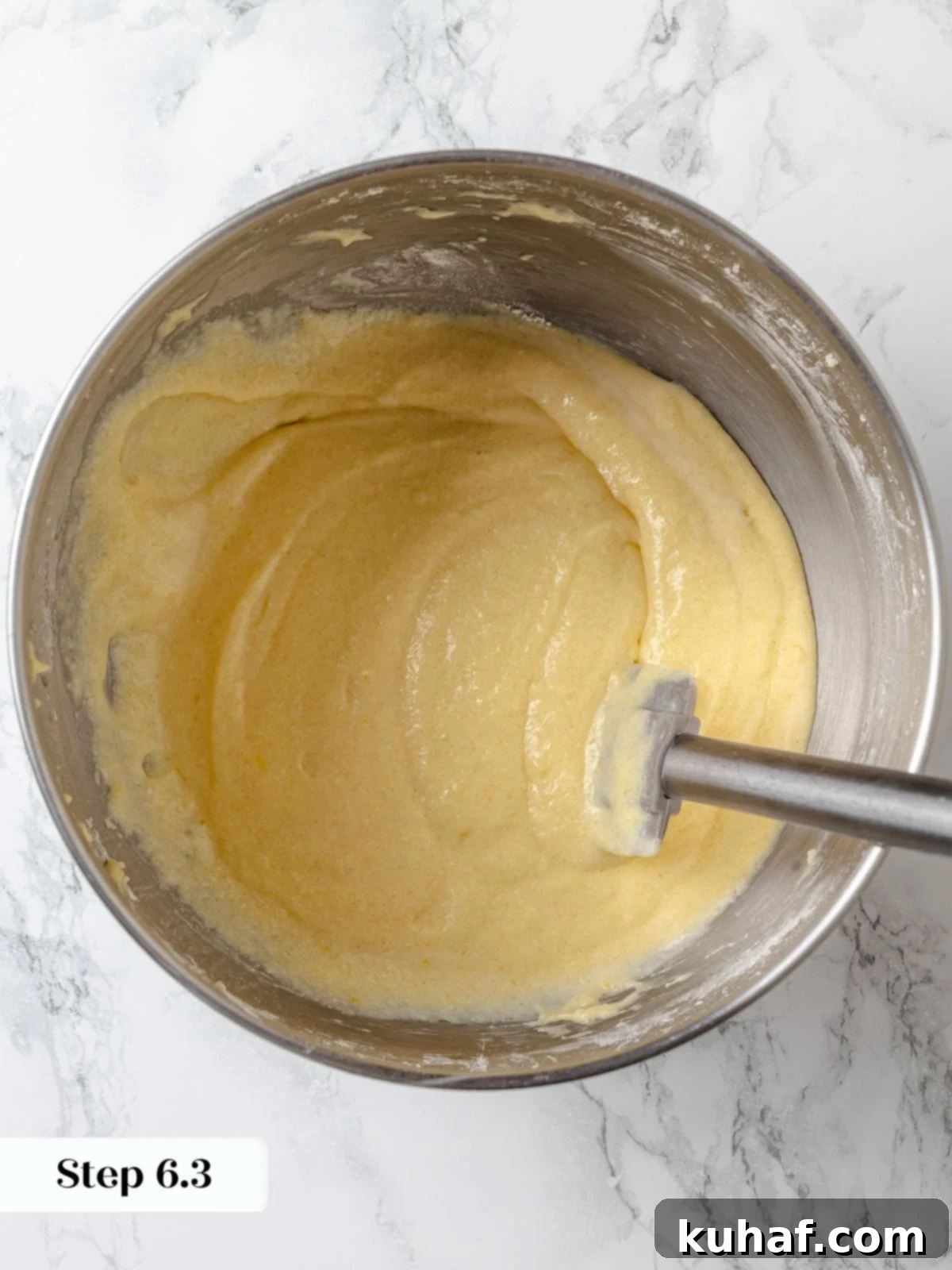 Finished lemon cake batter smooth, pale, and ready for baking.