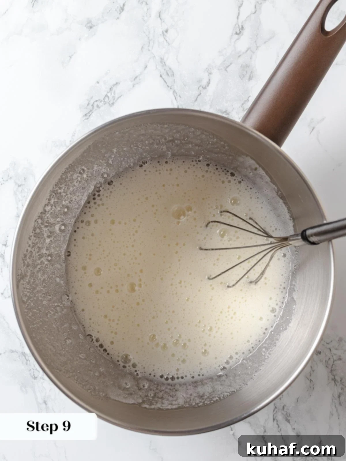 Egg whites and sugar cooking gently to prepare stable Swiss meringue base.
