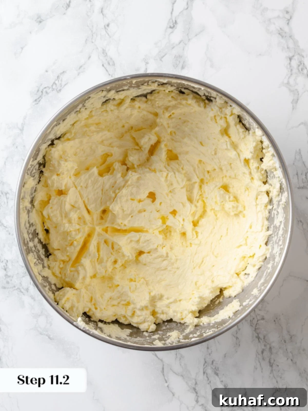 Soft butter incorporated into meringue to form silky buttercream frosting.