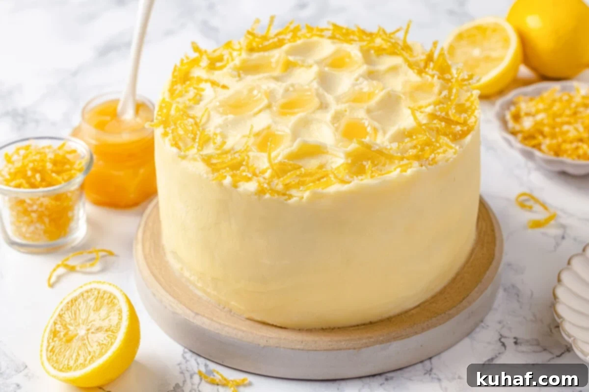 Lemon cake decorated with curls of lemon peel and soft buttercream swirls.