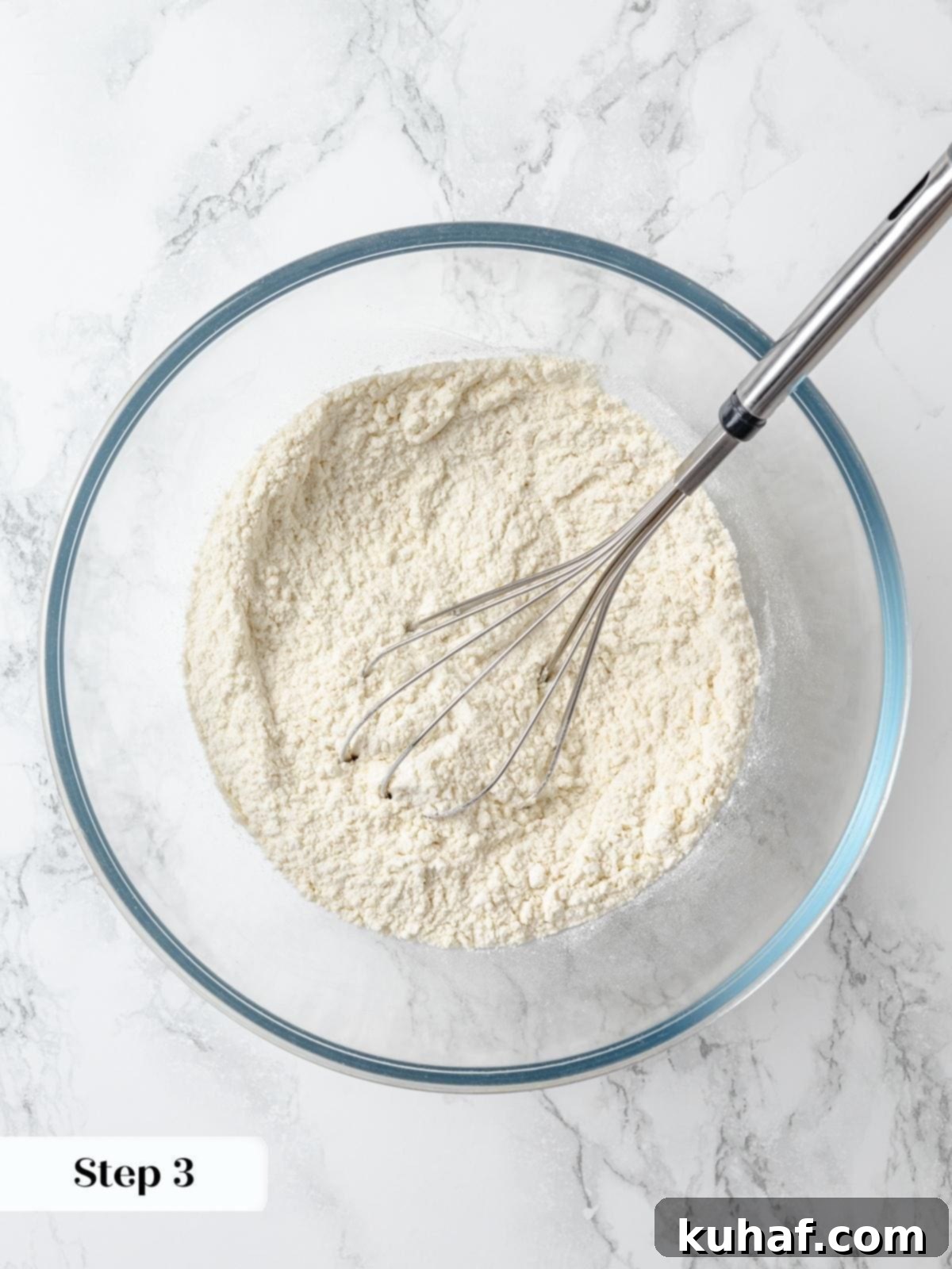 Whisk combining cake flour, baking powder, and salt for lemon cake batter.
