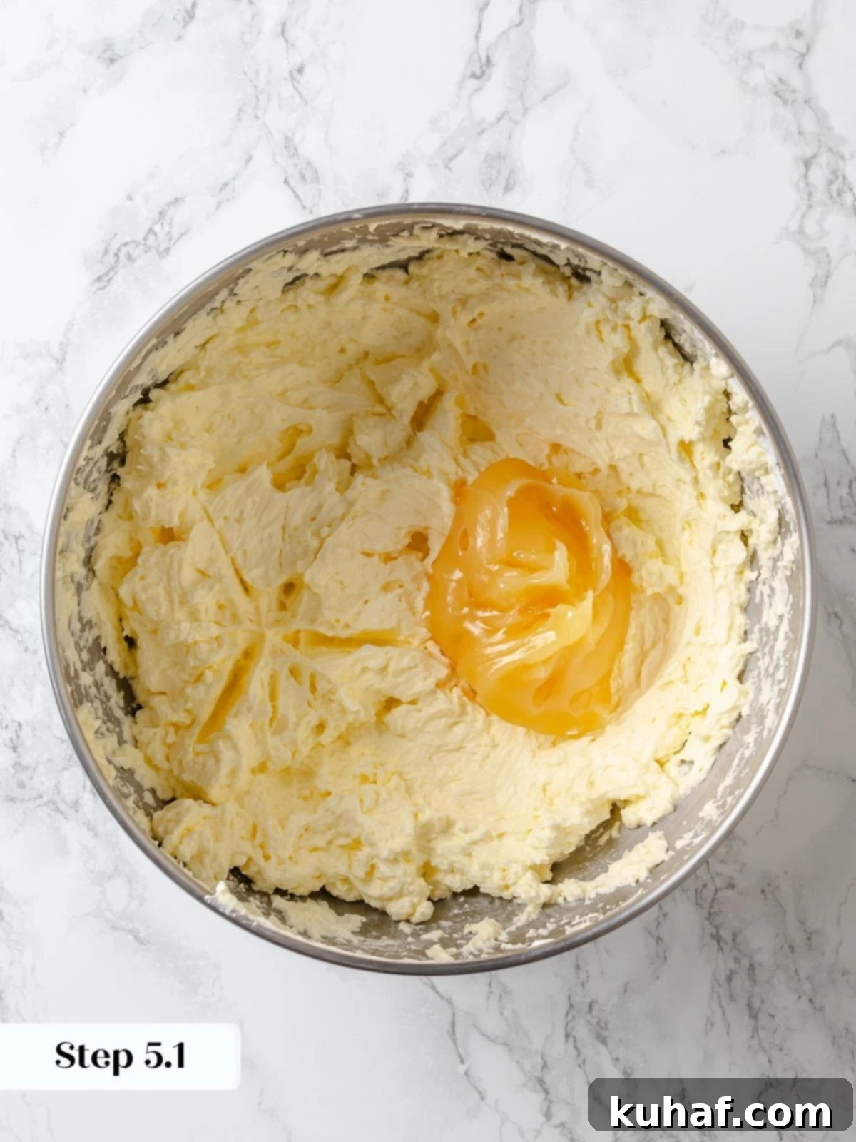 Adding lemon curd to buttercream.