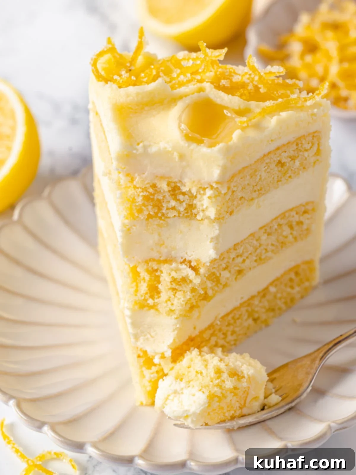 Bite of cake showing soft crumb and silky lemon buttercream.