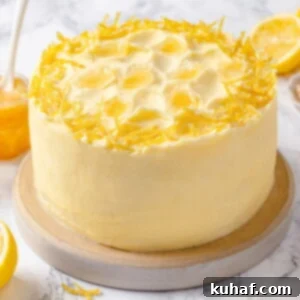 Cake topped with lemon Swiss meringue buttercream and fresh lemon peel.