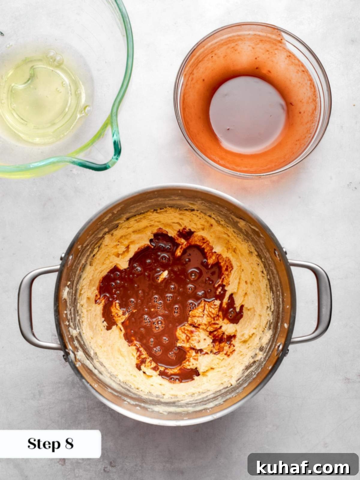 Melted German’s chocolate mixture being poured into the cake batter before mixing.