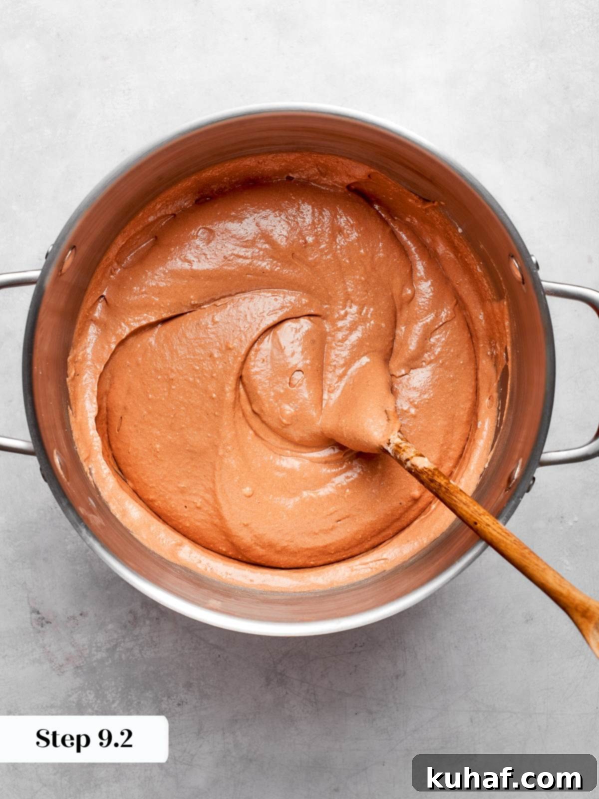 Thick chocolate batter with a glossy texture, prepared for baking into luscious cake layers.