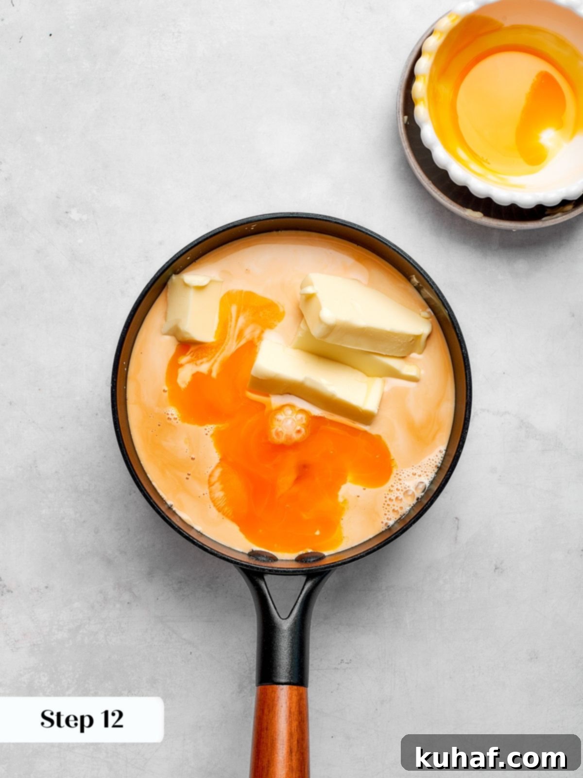 Custard base simmering on the stove, featuring evaporated milk, butter, sugar, and egg yolks.
