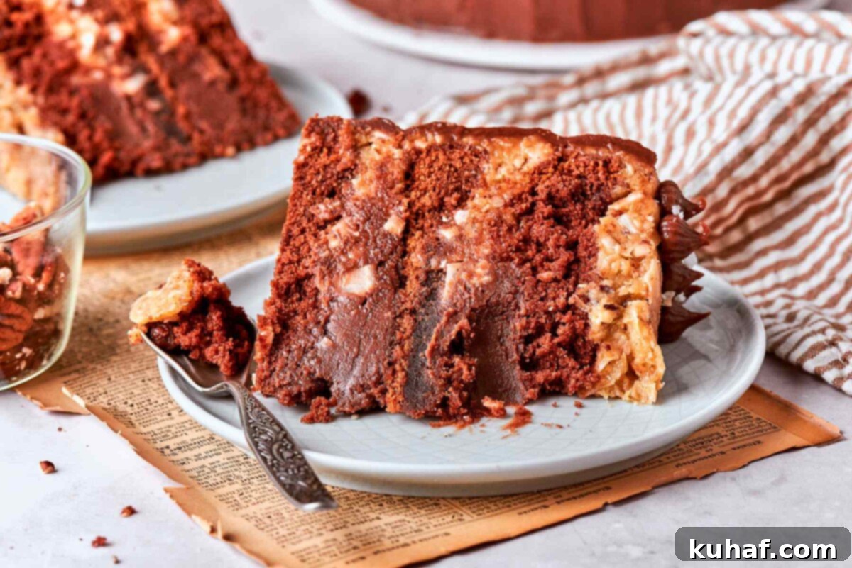 A slice of German chocolate cake with a bite taken, revealing the tender chocolate crumb.