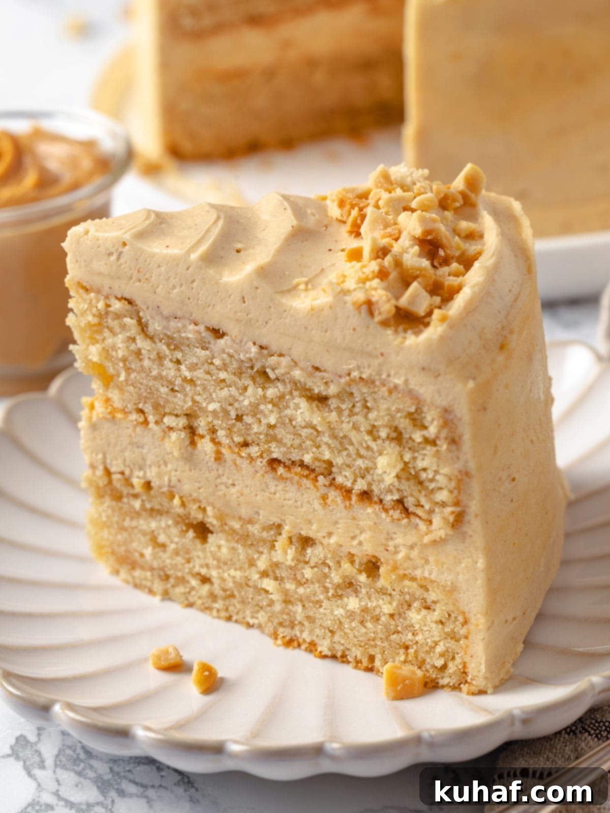 Peanut Butter Dream Cake 2 Single slice of peanut butter cake plated with thick buttercream.