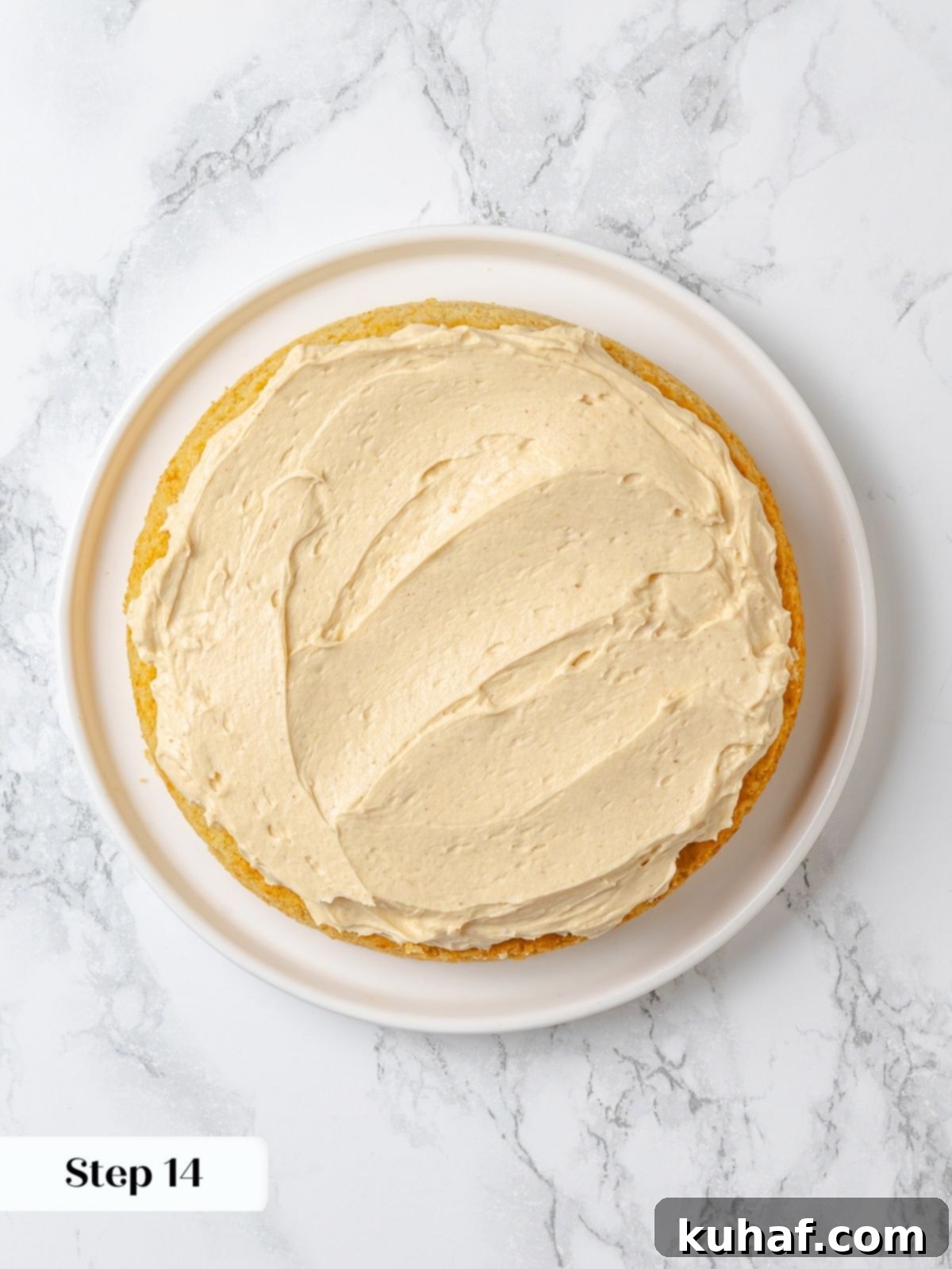 Peanut Butter Dream Cake 20 First cake layer spread evenly with thick peanut butter buttercream.