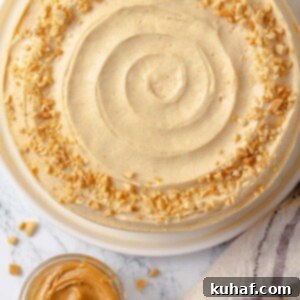 Peanut butter buttercream cake beautifully garnished with chopped roasted peanuts for added crunch.