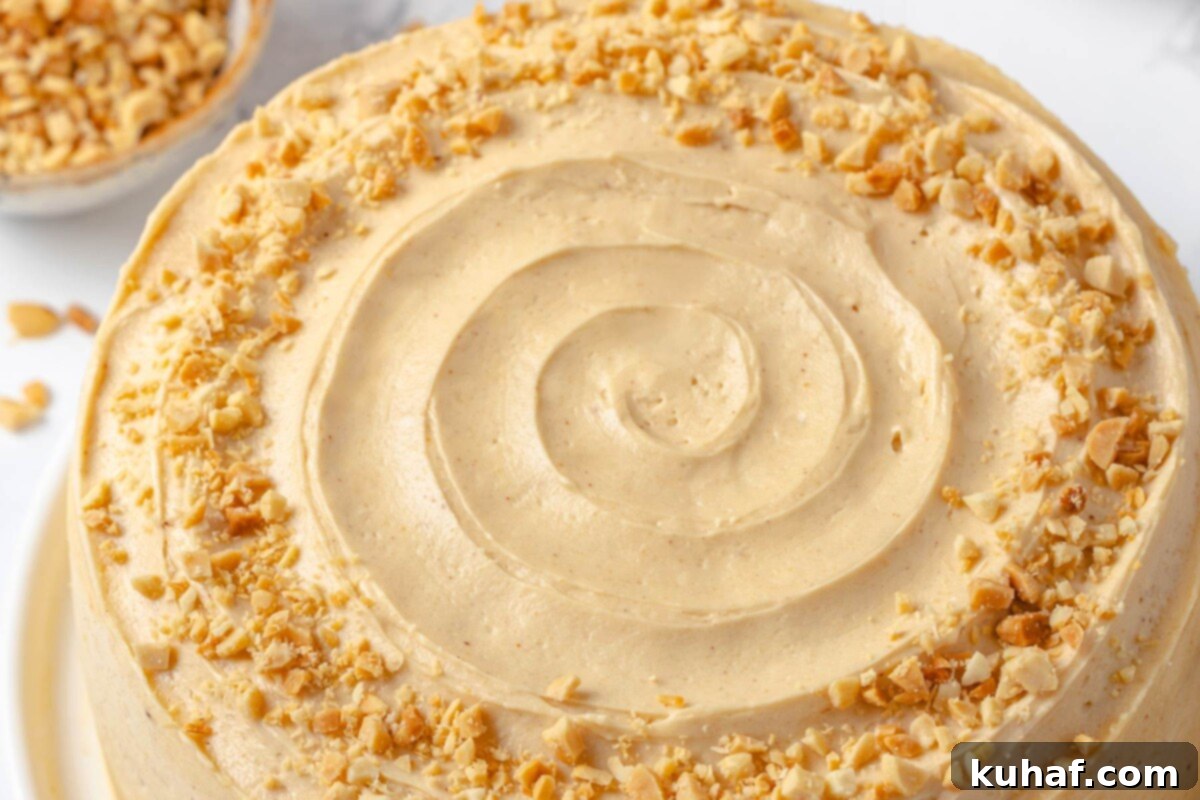 A beautifully decorated layer cake showcasing fluffy, smooth peanut butter buttercream frosting.