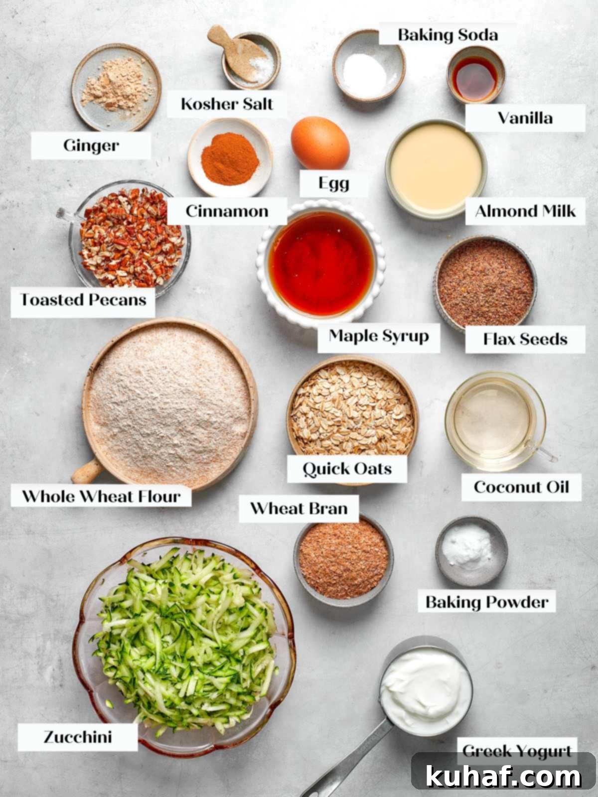 Ingredients for zucchini muffins including whole wheat flour oats yogurt and shredded zucchini.